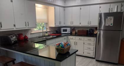 Spacious 4-bedroom house in charming Winston-Salem with WiFi and fenced in yard.