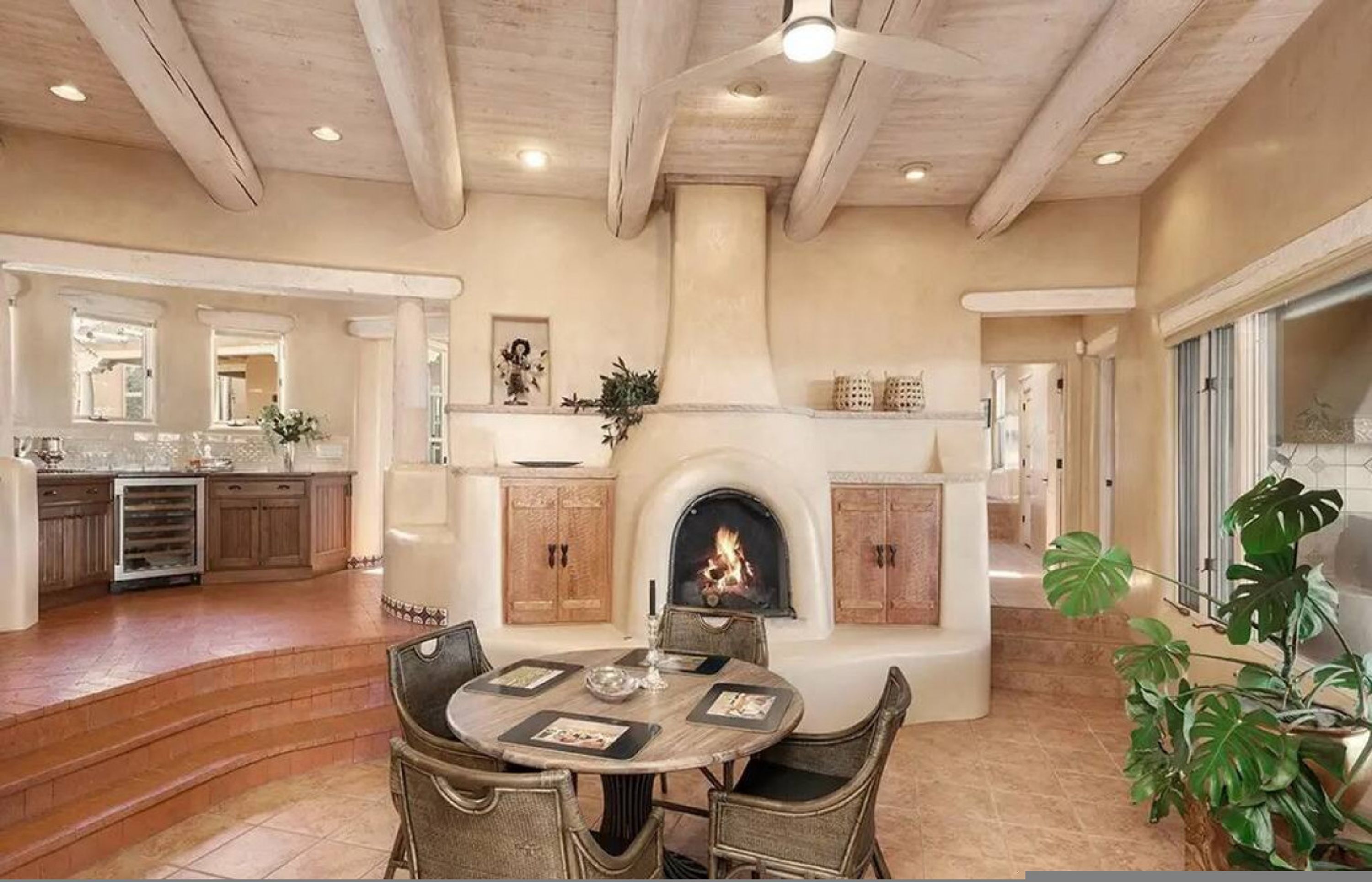 A spacious living area with a fireplace, dining table, and comfortable seating.
