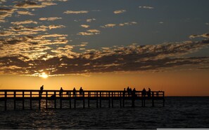 A pier extending into the water during sunset with people fishing. - Villa Tranquility Waterfront Pool Spa Retreat Near Fishermen s Village (Punta Gorda)
