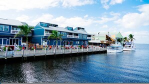 A waterfront hotel with a dock, a boat named "Island Star," and a pedestrian walkway. - Villa Tropical Waterfront Luxury Retreat Panoramic Water Views Pool Spa (Punta Gorda)