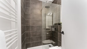 A modern bathroom with a glass-enclosed shower, a white toilet, and a white radiator. - Sweet chocolate room by  Charlie's choco factory - Perfect for up to 3 people! (Brugge)