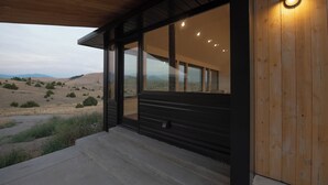 A modern building with large glass windows and a wooden exterior.