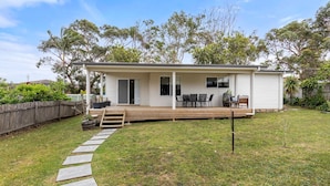 A single-story house with a covered patio, a small deck, and a fenced backyard. - This is Livin' - Fire Pit - 3 Mins Walk to Beach (Culburra Beach)