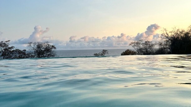 A calm sea with a clear sky and distant land. - Casa Jasmin Troncones (Troncones)