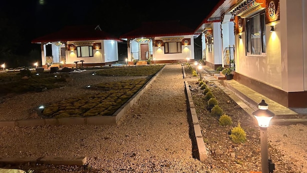 A building with multiple rooms, a gravel courtyard, and outdoor lighting. - Zen Resort (West Kameng)