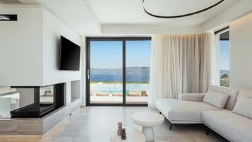 Exclusive Villa, 4 Bedrooms, Private Pool, Sea View | Living area | 55-inch Smart TV with satellite channels, fireplace