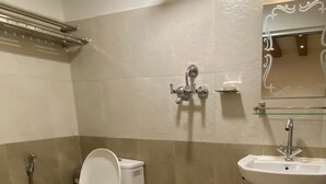 A bathroom with a toilet, a shower, and a sink. - Thani Boutique Hotel (Kathmandu)