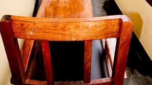 A narrow balcony with a wooden table and chairs, a small tree, and a building in the background. - Thani Boutique Hotel (Kathmandu)