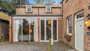 A brick cottage with a large glass door, a small window, and a doorbell. - No. 1 - Laurel Cottage - Pass the Keys (York)