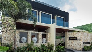 A modern building with large windows, stone walls, and a sign reading "Rahya Villas Complex". - Rahya Villas Complex (Kutuh)