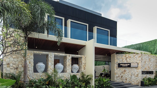 A modern building with large windows, stone walls, and a sign reading "Rahya Villas Complex". - Rahya Villas Complex (Kutuh)