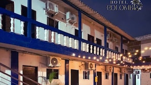 A hotel with a covered outdoor area, multiple air conditioning units, and a tiled floor. - Hotel Colombia del Golfo (Tolú)