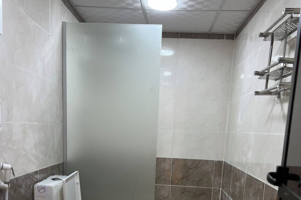 A modern bathroom with a toilet, sink, and shower area.