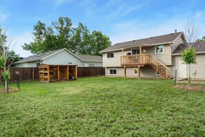A two-story house with a covered patio and a wooden staircase leading to a balcony. - Rmnp Retreat - Group-friendly Home Near Estes Park (Loveland)
