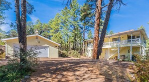 A two-story house with a covered porch and a garage. - Sleeps 12-Near Lake-Family~Mountains|Cedar Escape (Show Low)