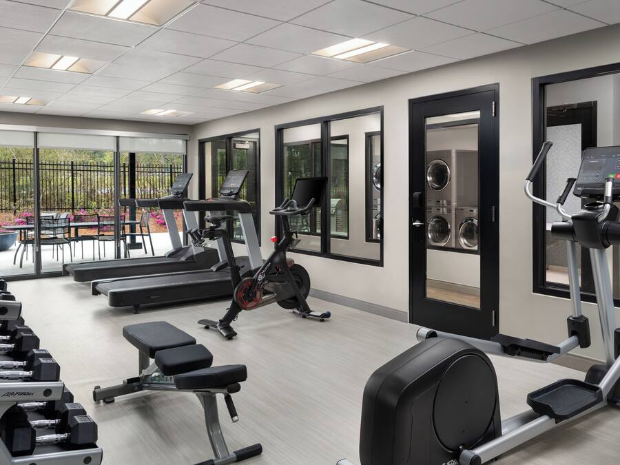 A gym with treadmills, stationary bikes, and weight machines.