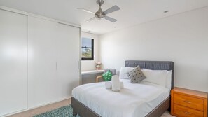 A bedroom with a bed, a nightstand, a window with a view, and a ceiling fan. - Clifftop Luxury With Pool ~ Ultimate outdoor experience with a private pool (Kiama)