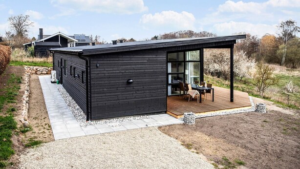A modern black house with a covered patio and a large glass door. - 4 bedroom awesome home in Slagelse (Slagelse)