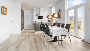 A modern dining area with a large table, chairs, and pendant lights. - 4 bedroom awesome home in Slagelse (Slagelse)