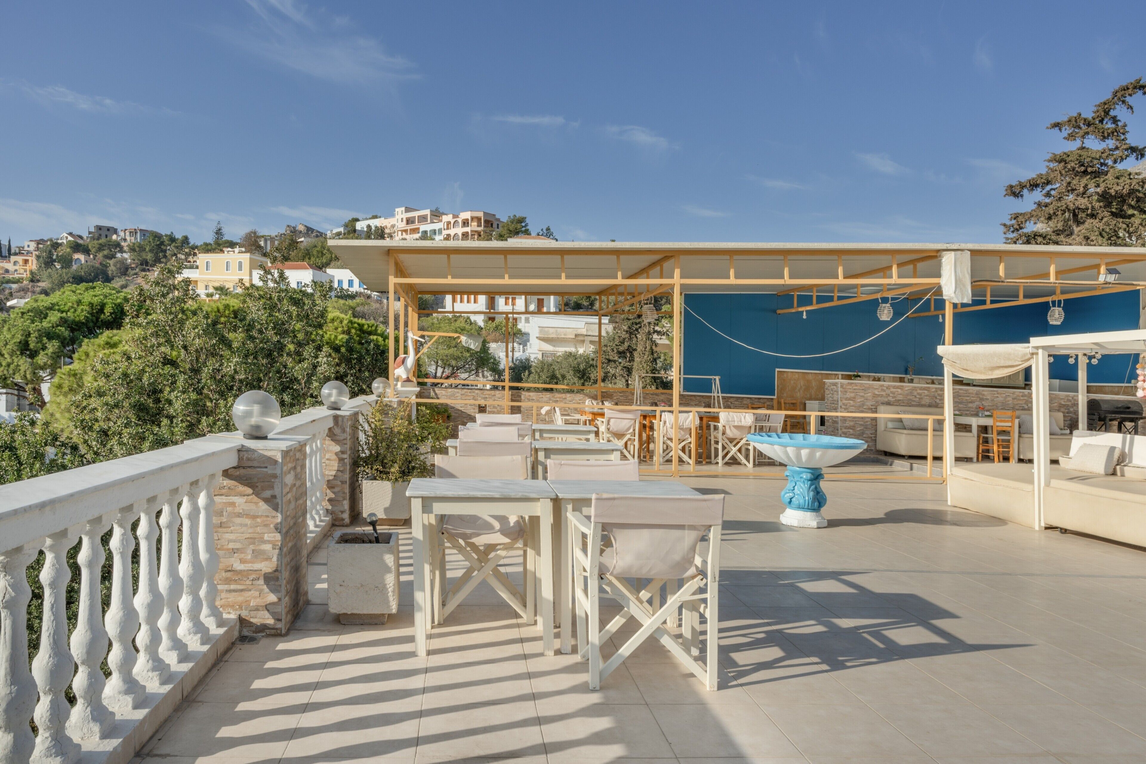 A rooftop terrace with outdoor seating, a pool table, and a view of the surrounding buildings.
