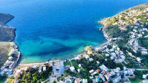 An aerial view of a coastal town with clear blue waters, a small island, and densely packed buildings. - Apartment 'Double Studio No 1' with Sea View, Wi-Fi and Air Conditioning (Panormos Kalymnos)