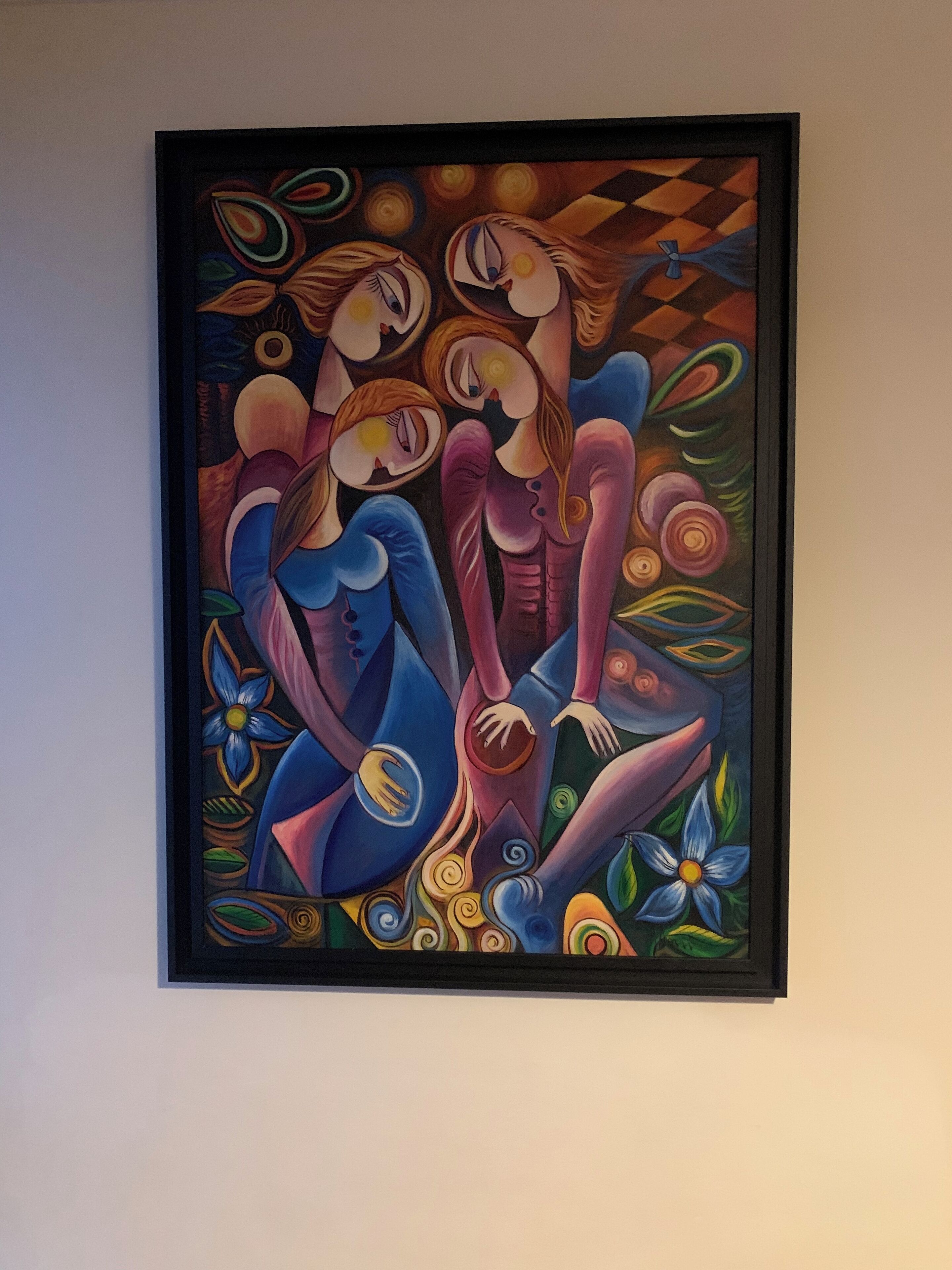 A framed abstract painting with geometric shapes and figures.
