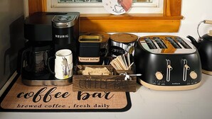 A kitchen area with a coffee station, including a Keurig coffee maker, a mug, and a coffee grinder. - 4BR Summer Home For 10ppl with Game Room -White Mtns! (Woodstock)