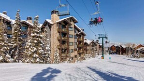 A ski resort with multi-story buildings, ski lifts, and snow-covered trees. - Abode at Silver Summit, ski-in/ski-out, hot tub, pool table, Silver Lake (Park City)