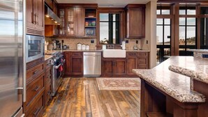 A kitchen with wooden cabinets, a stainless steel refrigerator, a dishwasher, and a large window. - Abode at Silver Summit, ski-in/ski-out, hot tub, pool table, Silver Lake (Park City)