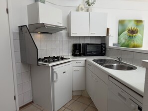 Fridge, stovetop, dishwasher, coffee/tea maker