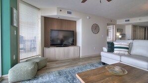 A living room with a television, sofa, and coffee table.