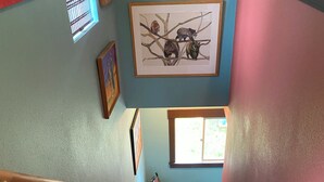 A staircase with a handrail, carpeted steps, and a chair near a window. - Cozy 1-bedroom stand alone apartment in fantastic Missoula, MT.!!! (Missoula)