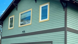 A two-story house with a garage, a wooden fence, and a clear sky. - Cozy 1-bedroom stand alone apartment in fantastic Missoula, MT.!!! (Missoula)