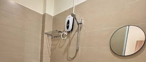 A modern bathroom with a toilet, a sink, and a shower.
