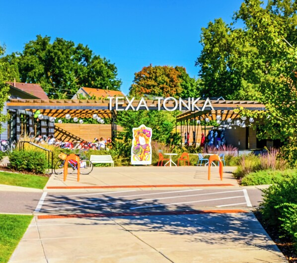 A covered outdoor area with a sign reading "TEXA-TONKA". - We Connect Co-Living (St. Louis Park)