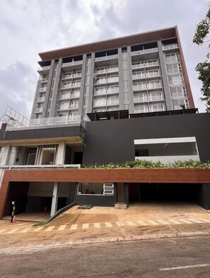 A multi-story building with a flat roof, large windows, and a modern architectural design.