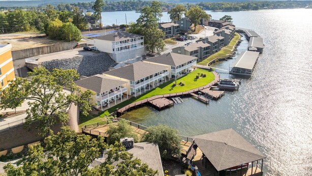 A waterfront hotel with multiple buildings, a dock, and a boat dock. - Catalina Lakeside Retreat: Lakefront, Dock Access, Grill, Views, and Near Hot Springs National Park! (Hot Springs)