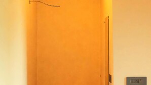 A narrow hallway with a wooden ceiling and recessed lighting. - ISOL Nature Resort (Rishikesh)