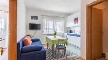 Apartment (Comfort One Bedroom Apartment with Ba) | Living room | 32-inch flat-screen TV with cable channels