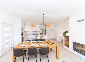 A modern kitchen with white cabinets, a central island, and pendant lighting. - Scenic Elegant Trogir Villa With Pool (Trogir)