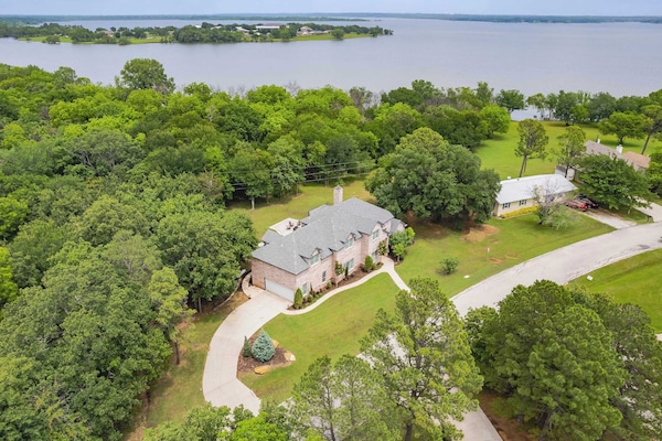 Breathtaking aerial view—our property nestled near the lake, surrounded by natural beauty.