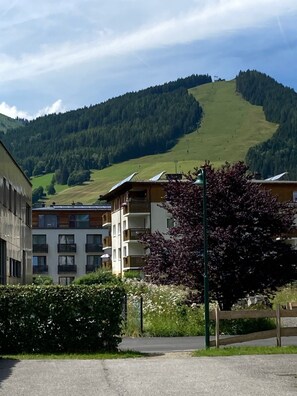 A building with multiple floors, balconies, and solar panels.