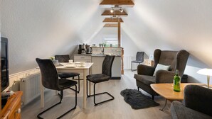 Una habitación moderna estilo loft con comedor, cocina y zona de estar.