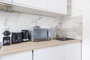 Fridge, microwave, stovetop, coffee/tea maker