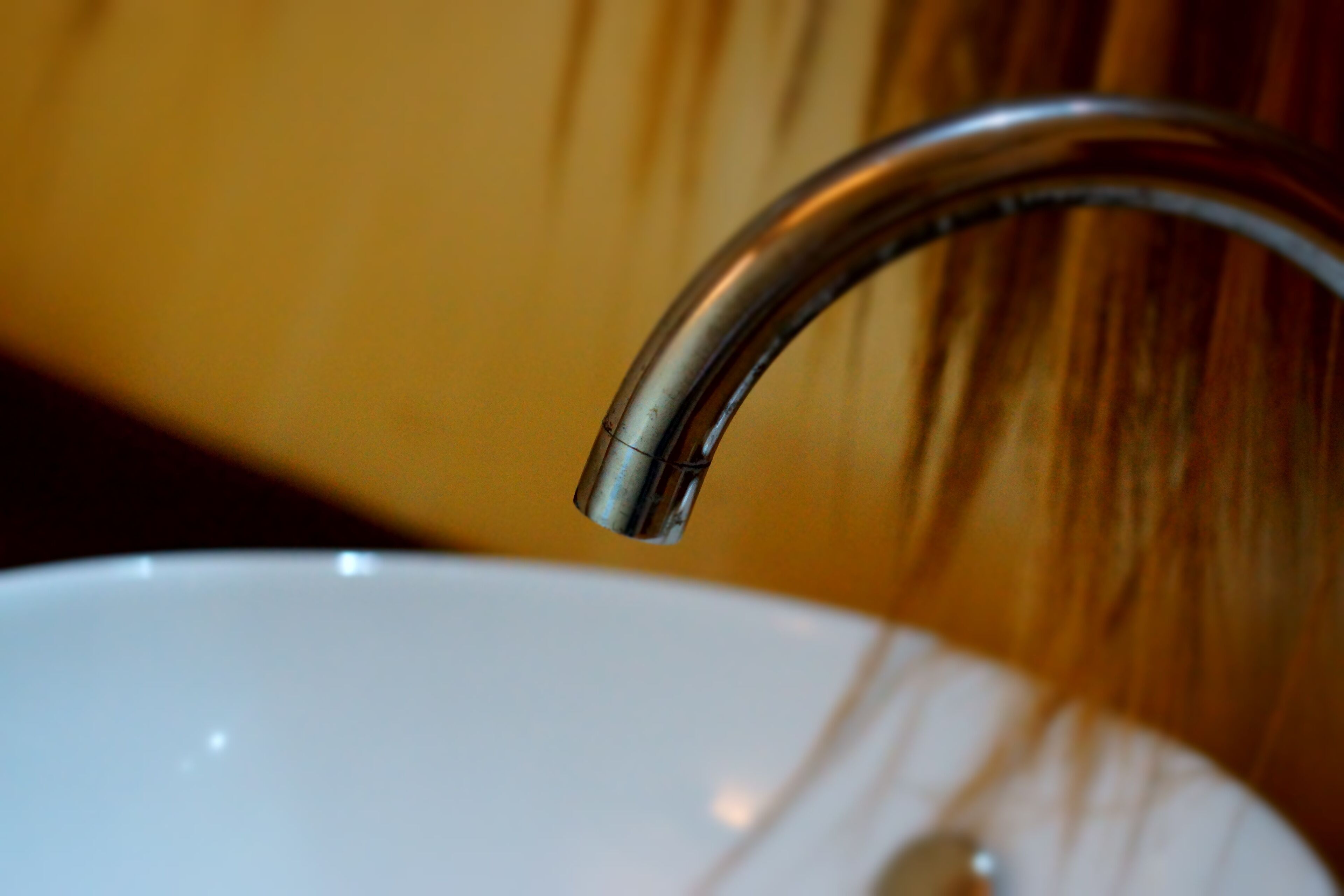 A close-up of a bathroom sink with a chrome faucet.