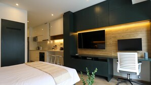 A modern hotel room with a bed, desk, and TV. - w* | Superb Loft w/ Balcony in Barranco (Lima)