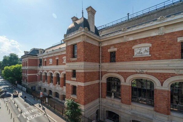 A historic building with red brick facade, arched windows, and classical decorative elements.
