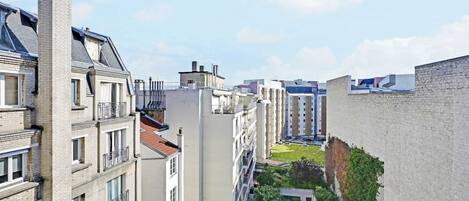 A high-rise building with multiple balconies, a courtyard, and a mix of architectural styles.