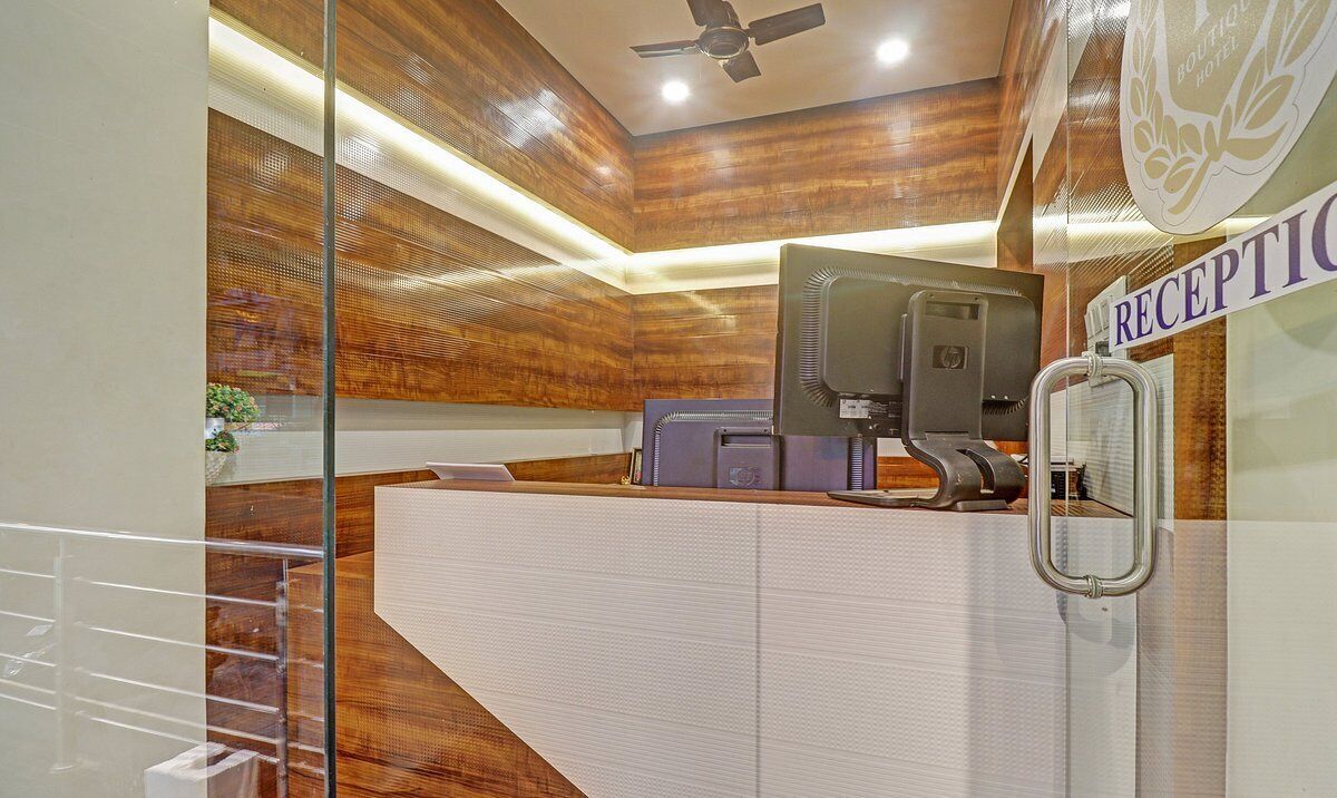 A reception area with a reception desk, a ceiling fan, and a sign that reads "RECEPTION".
