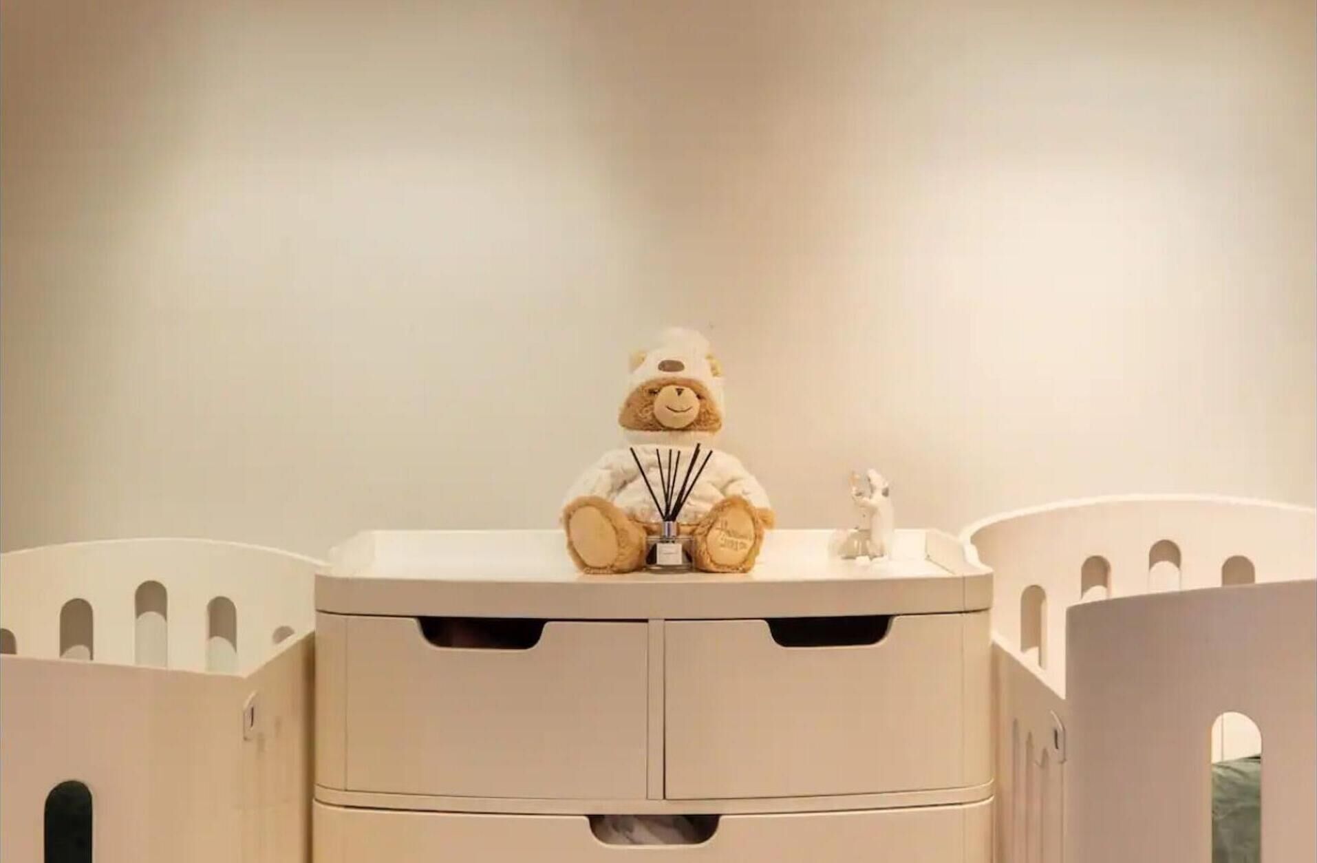 A beige cabinet with two drawers and a small shelf.